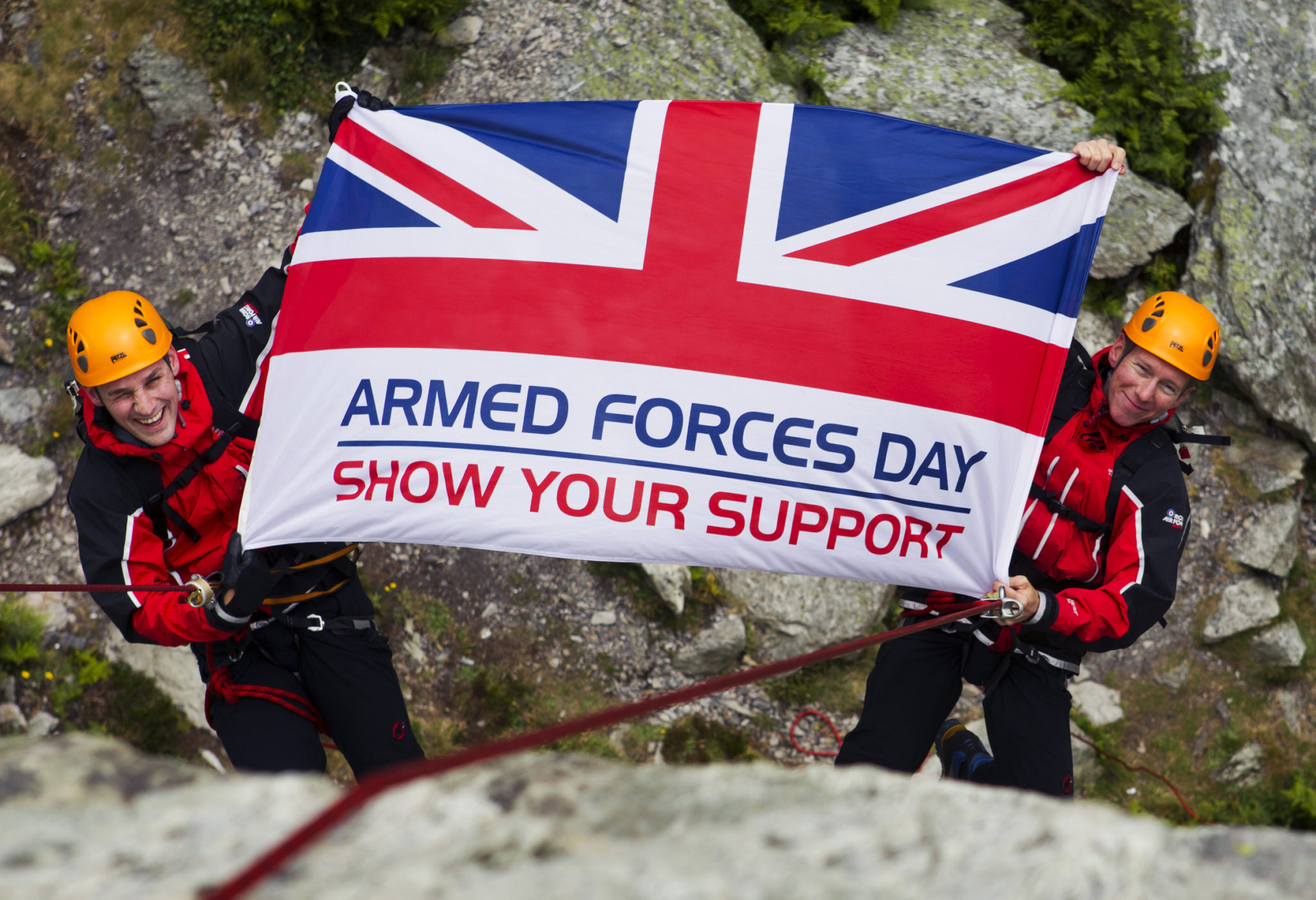 climbers holding the Armed Forces Day Flag