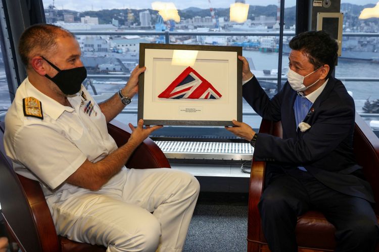 Cdre Moorhouse presents Japanese Defence Minister Kishi with the White Ensign that flew as HMS Queen Elizabeth entered Japan 6 Sept 2021 FLEET-20210906-AV0050-053 CREDIT Crown Copyright